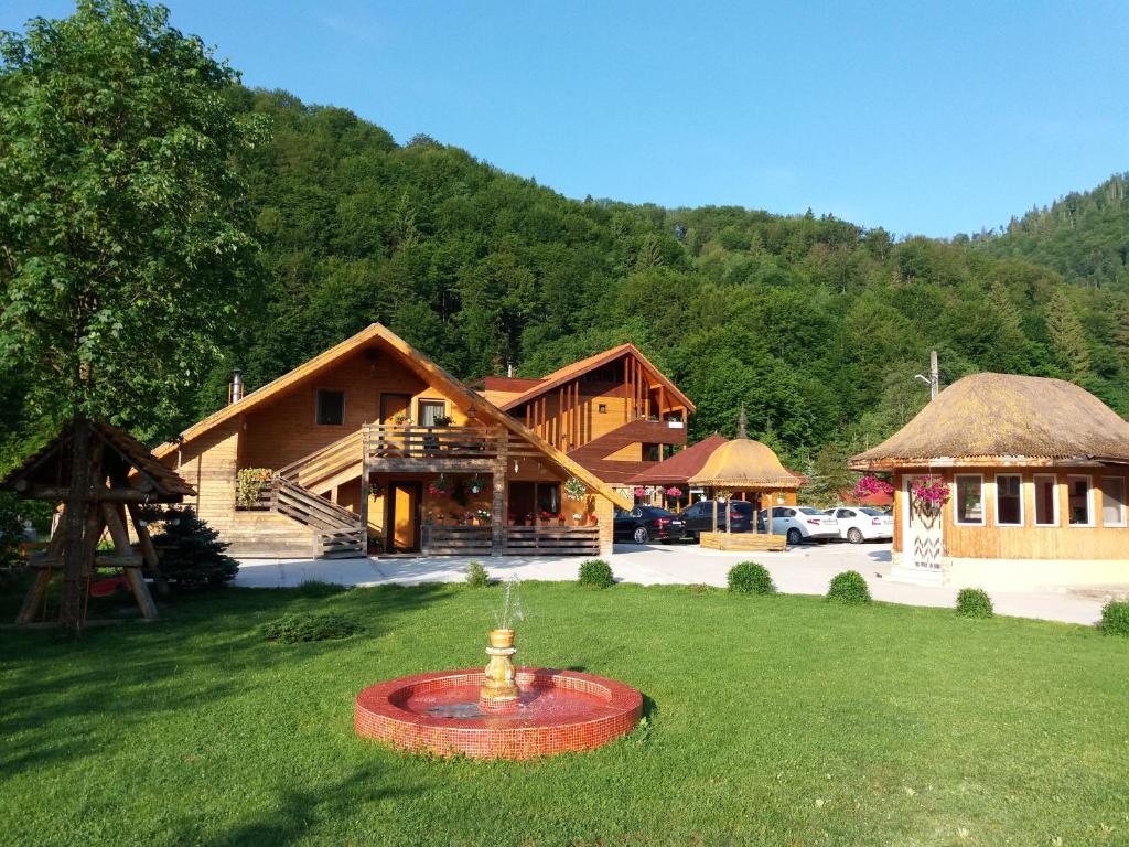 a resort with a fire hydrant in the middle of a yard at Green Eden Lepsa 2 in Lepşa