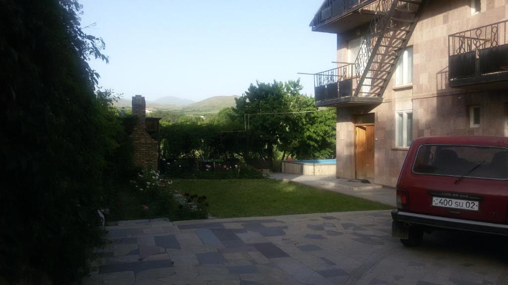 a red car parked in front of a building at Apricot Tree B&B in Yeghegnadzor