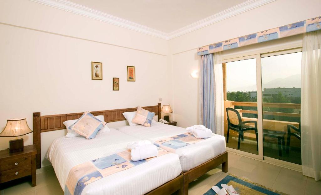 Postel nebo postele na pokoji v ubytování 4S Hotel Dahab