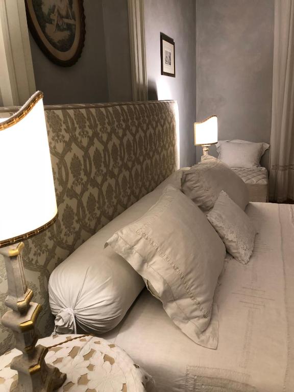 Postel nebo postele na pokoji v ubytování Le Case Di San Vitale