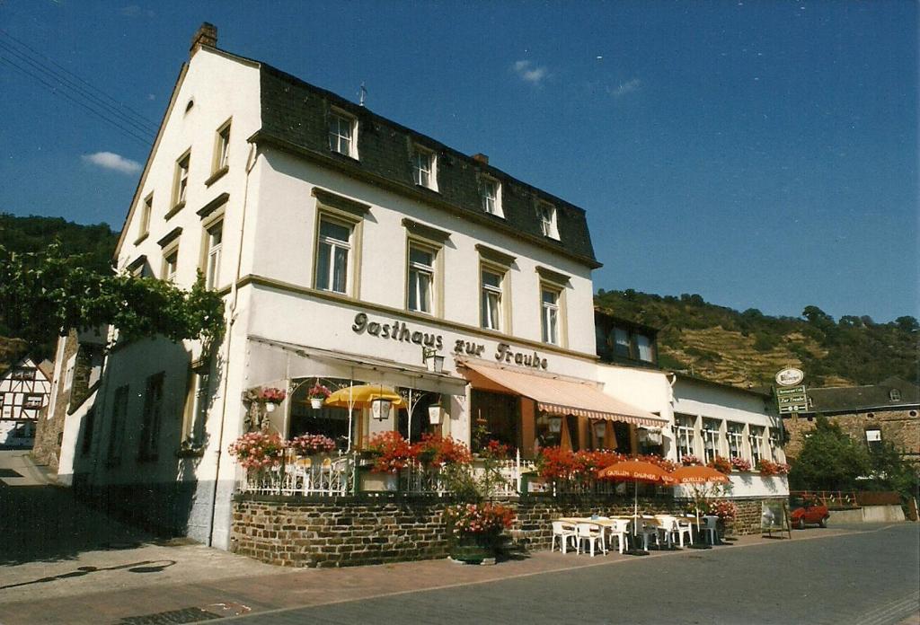 Hatzenport的住宿－Gasthaus Zur Traube，前面设有桌椅的建筑