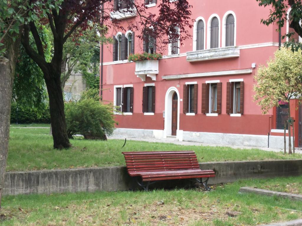a park bench in front of a pink building at Biennale in Venice