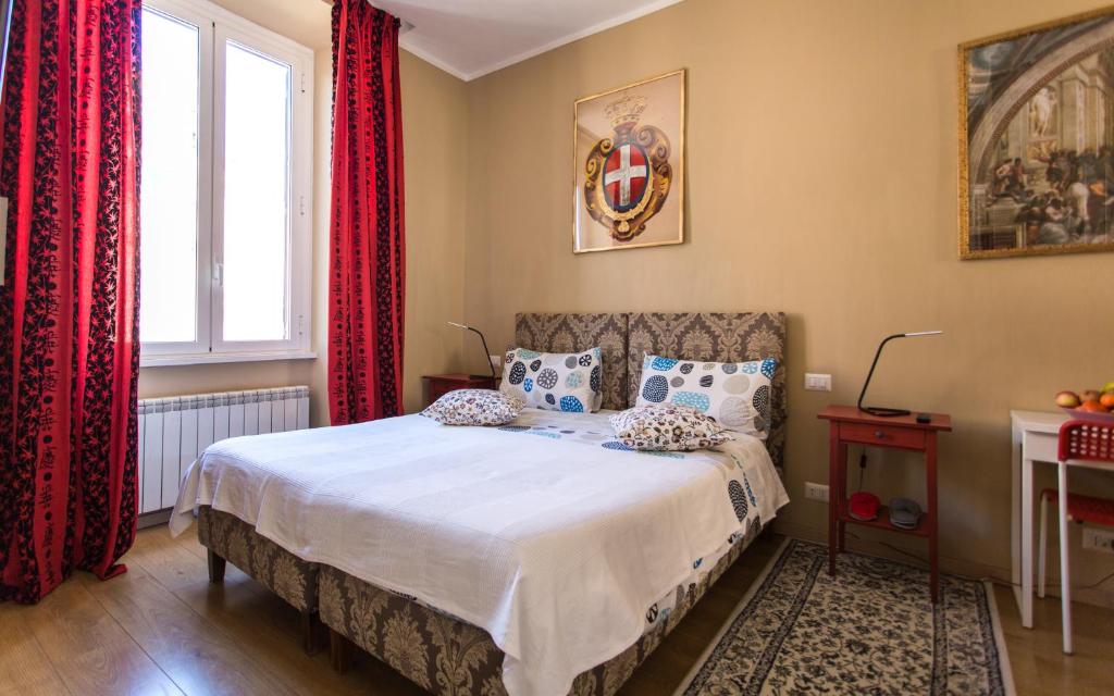 a bedroom with a bed with red curtains at Kiss Inn in Rome