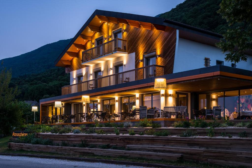 a building with a mountain in the background at Atmospheres in Le Bourget-du-Lac