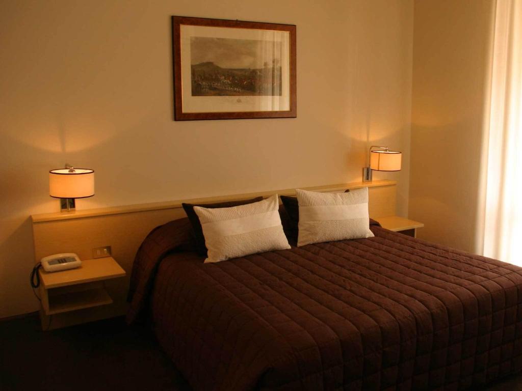 Postel nebo postele na pokoji v ubytování Hotel Ancora Riviera