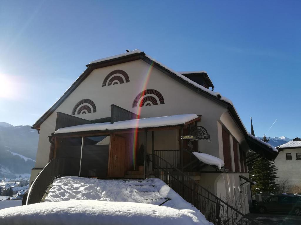 a house with snow on the front of it at Premium Appartements Di Bora in Sankt Michael im Lungau
