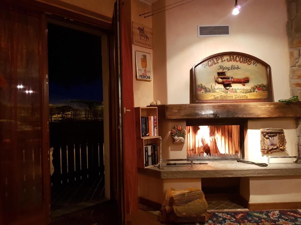 a fireplace in the corner of a living room at Casadolcino in Campodolcino