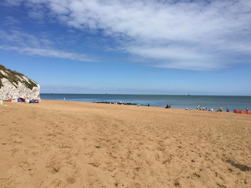 a sandy beach with a group of people on it at Seaview Cottage in Broadstairs