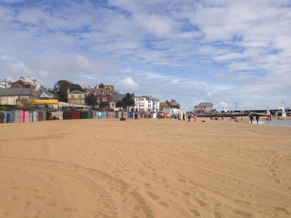 a group of people walking on the beach at Seaview Cottage in Broadstairs