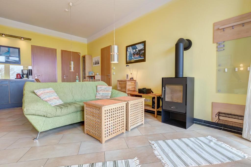 a living room with a couch and a fireplace at Ferienwohnung Hering in Ueckeritz