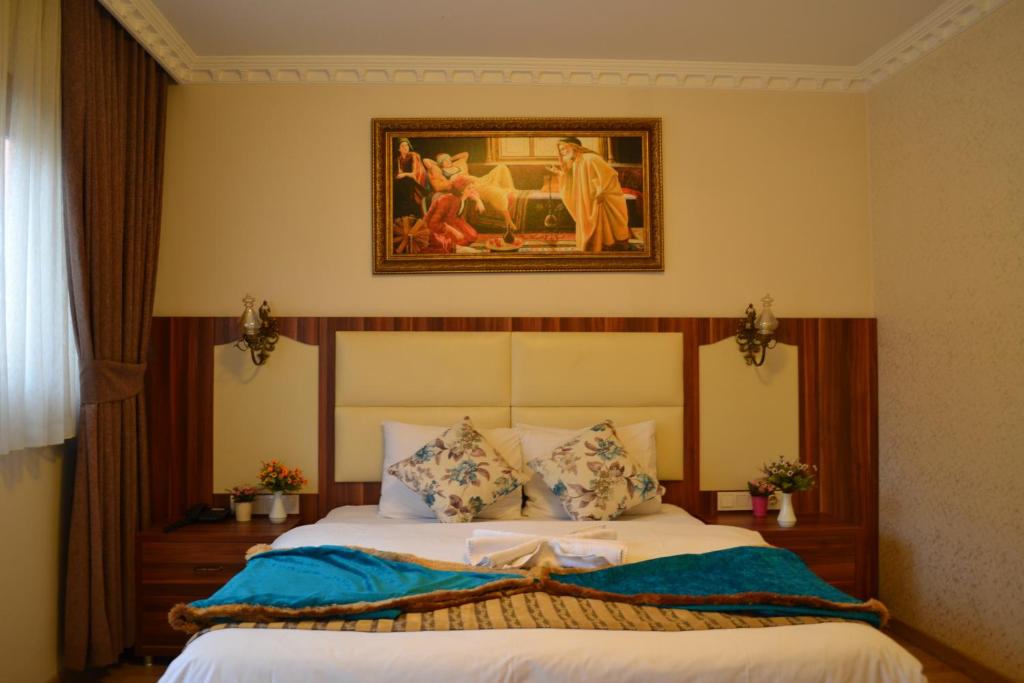 a bedroom with a bed with a picture on the wall at Peradise Hotel in Istanbul