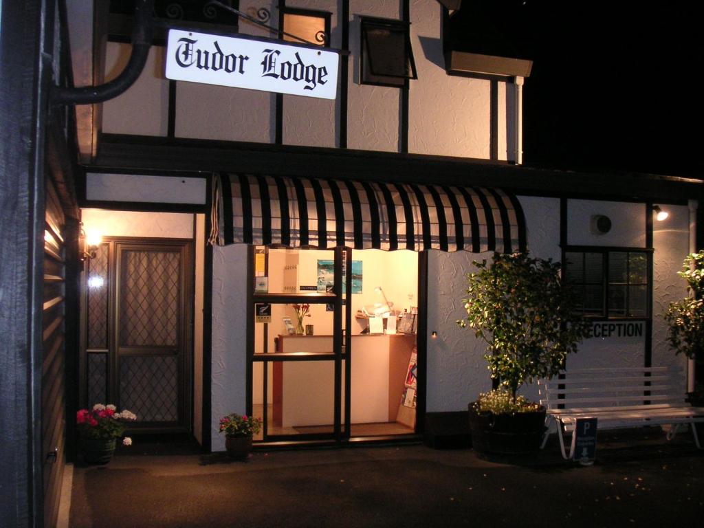 a store front of a store with a sign on it at Tudor Lodge Motel in Nelson