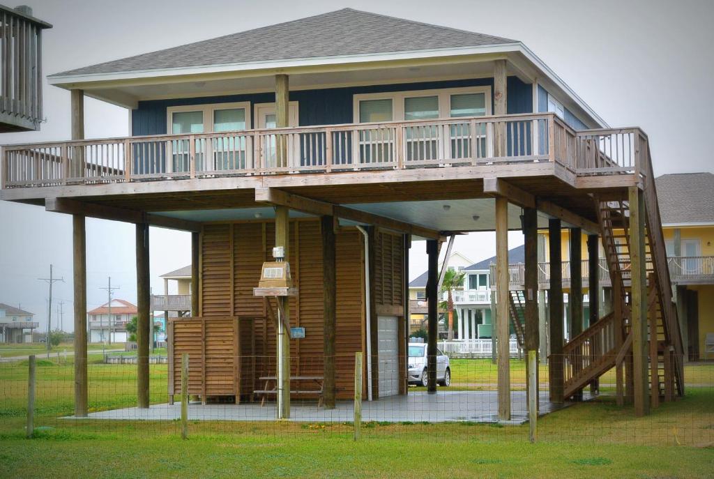 a large house with a deck on top of it at 1 Coastal Calm Home in Bolivar Peninsula