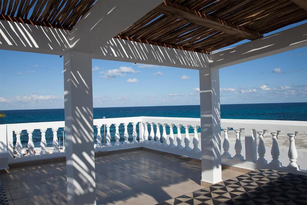 a view of the ocean from the porch of a house at Casa el Pio in Isla Mujeres