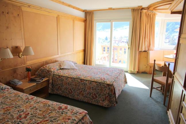 Postel nebo postele na pokoji v ubytování Hotel Catinaccio Rosengarten
