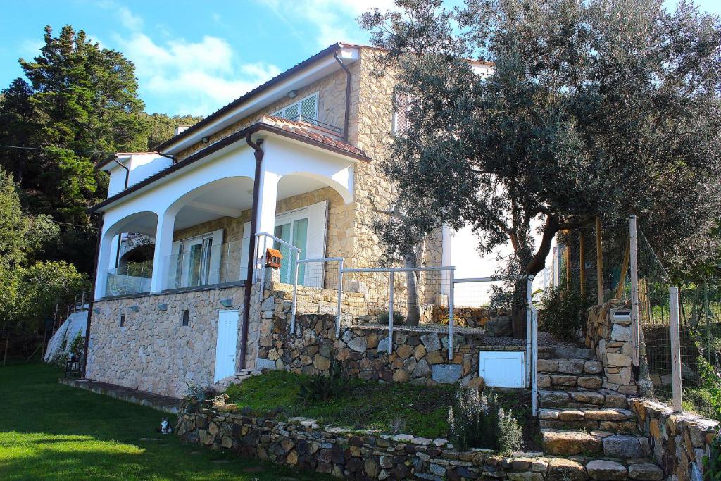 a small house with a stone wall at Country House Tagliaferro in Marciana Marina