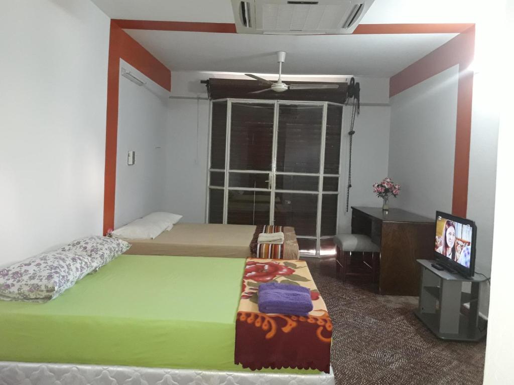 Postel nebo postele na pokoji v ubytování Nueva Alborada Lodging House