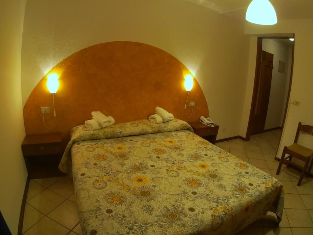Postel nebo postele na pokoji v ubytování Hotel Salgetti