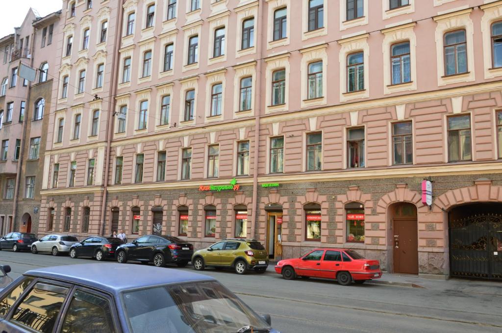 a large building with cars parked in front of it at Calendar in Saint Petersburg
