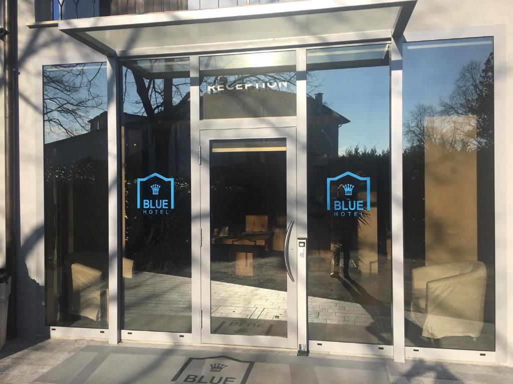 a glass door to a building with a table in it at Blue Hotel in Suzzara