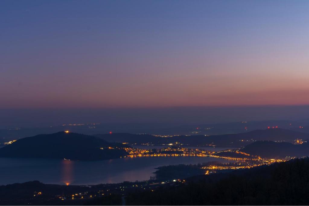 a view of a city and a lake at night at Hotel Loggas in Kastoria
