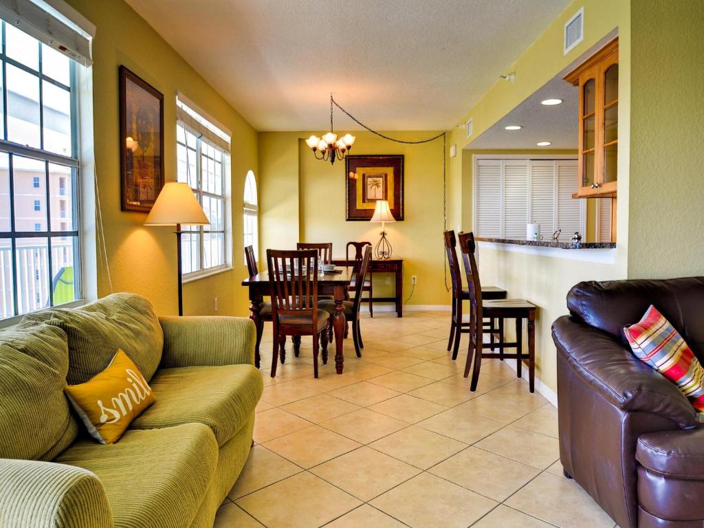 a living room with a couch and a dining room at Dockside Condos 602 Waterfront Condo 437 in Clearwater Beach