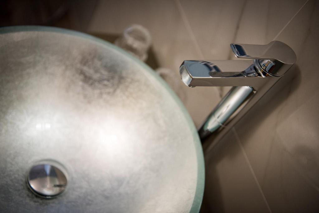 a close up of a bathroom sink with a faucet at Residenza Conte di Cavour & Rooftop in Florence