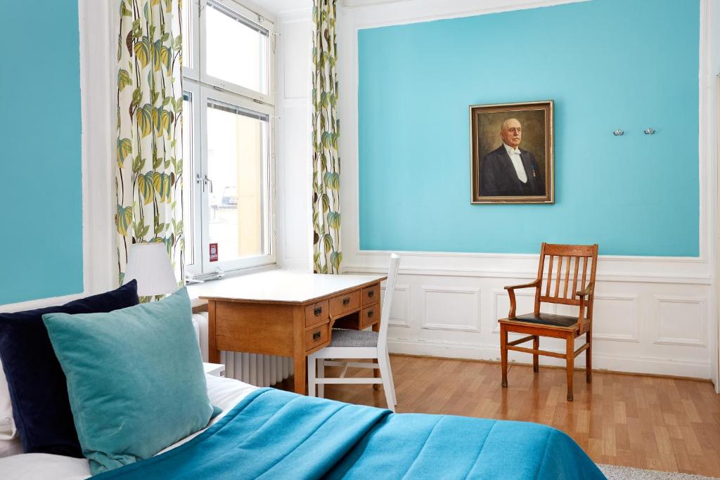 a bedroom with a bed and a desk and a chair at Hotel Hornsgatan in Stockholm