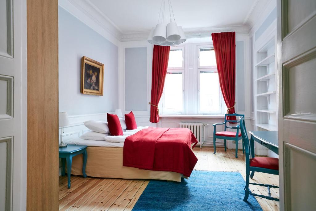 a bedroom with a bed and a desk and a window at Hotel Hornsgatan in Stockholm