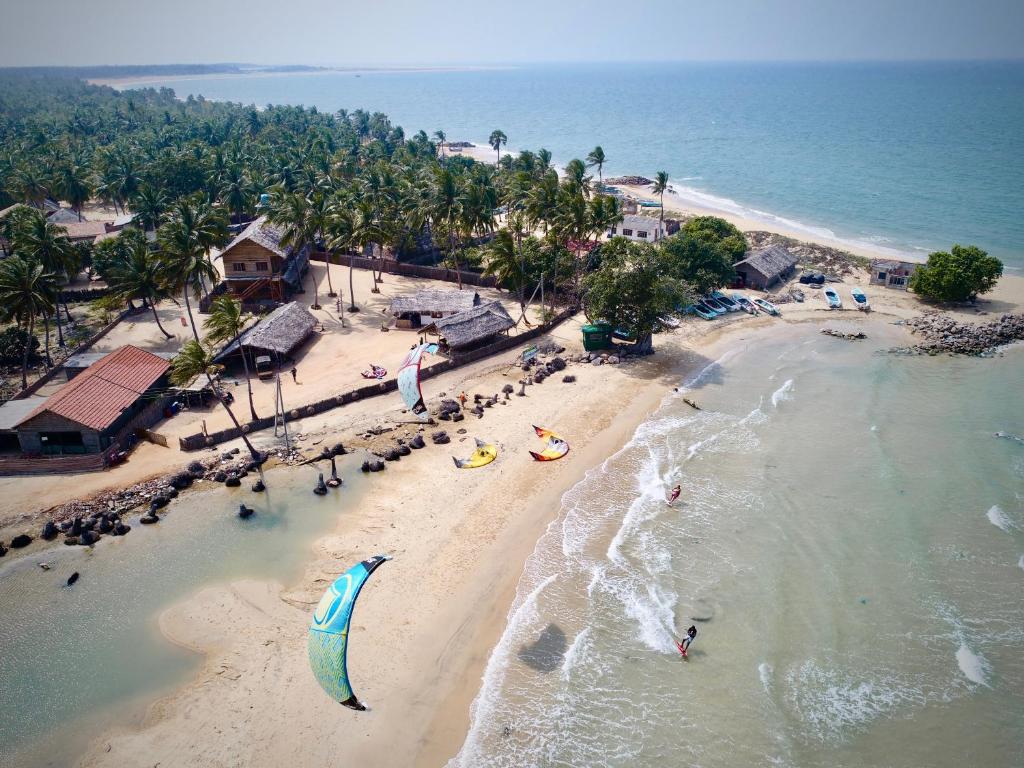 an overhead view of a beach with people in the water at Surfpoint Sri Lanka Kite Village in Kalpitiya