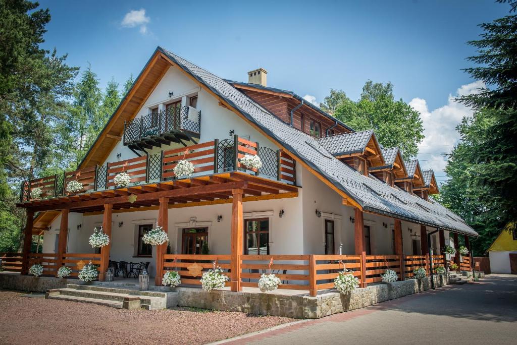 una casa con techo de gambrel y balcón en Dolce Vita en Ustroń
