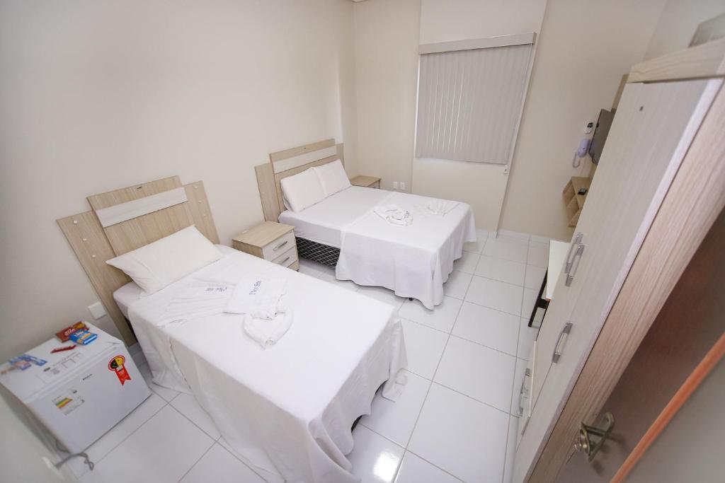 Postel nebo postele na pokoji v ubytování O Neves Hotel