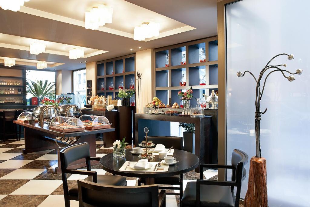 a restaurant with two tables and chairs and a counter at Daios Luxury Living in Thessaloniki