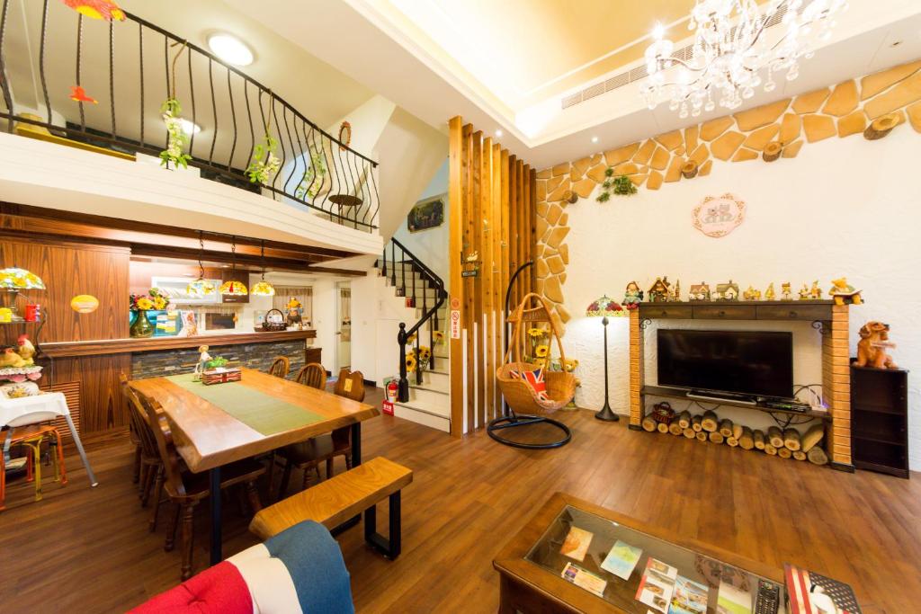 a living room with a table and a fireplace at British Country Inn B&amp;B in Luodong