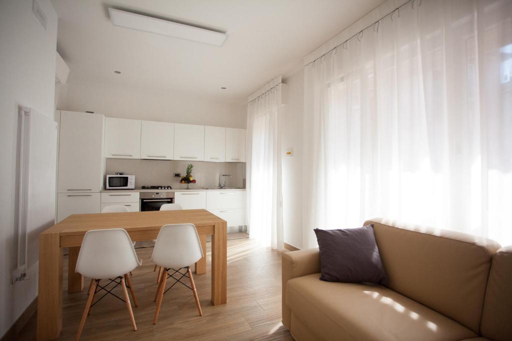 a living room with a table and a couch at Residence Torino in Chioggia
