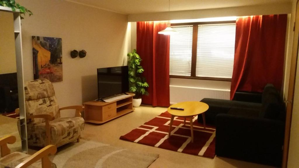 a living room with a couch and a table at Nice spacious home in Vaasa