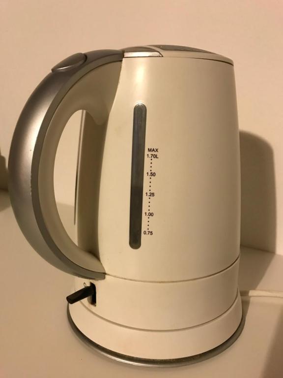 a tea kettle is sitting on top of a refrigerator at Le Magnolie Agriturismo in Verolanuova
