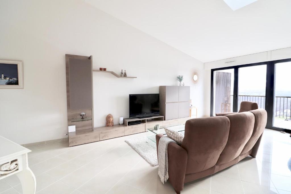 TV a/nebo společenská místnost v ubytování Appartement T4 Vue Unique