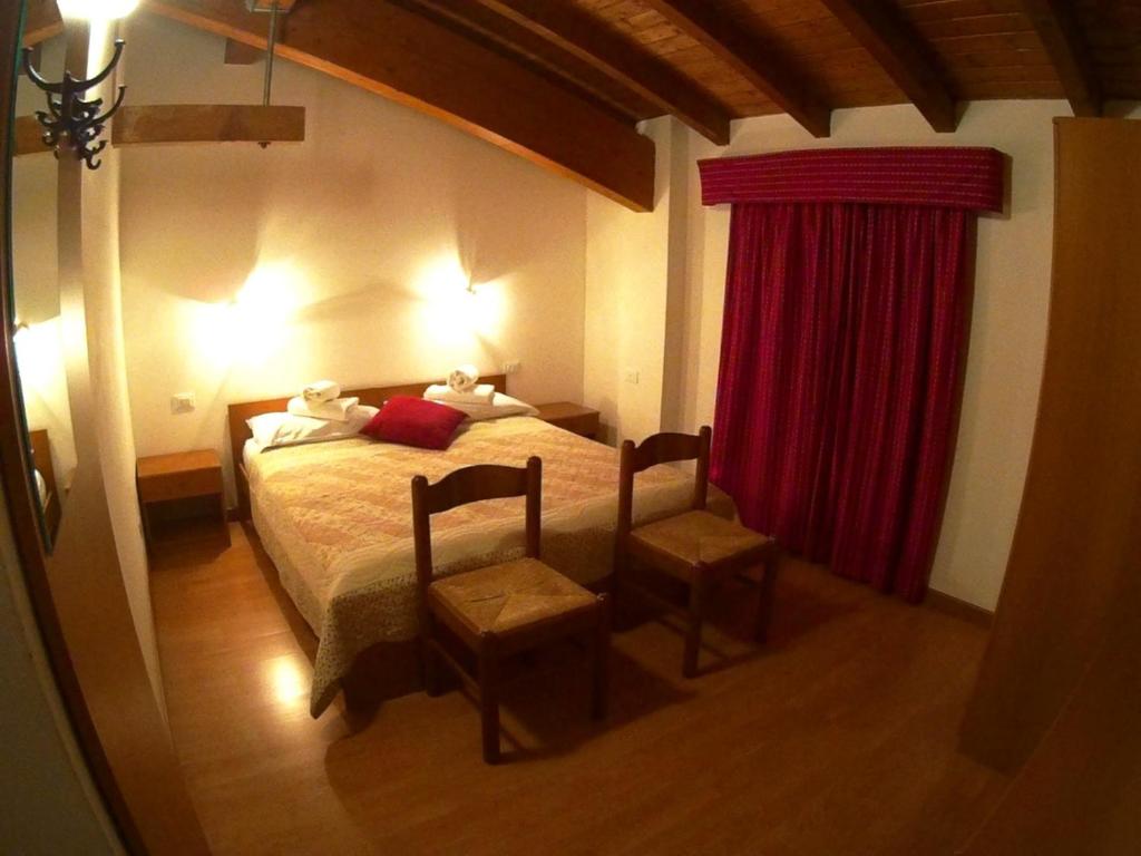 Postel nebo postele na pokoji v ubytování Hotel Salgetti
