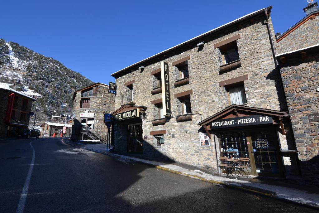 an old stone building on the side of a street at Hotel Micolau in Arinsal