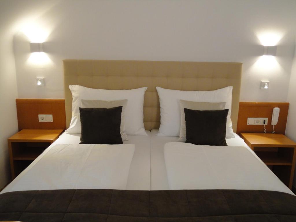 Ein Bett oder Betten in einem Zimmer der Unterkunft City Hotel Albrecht