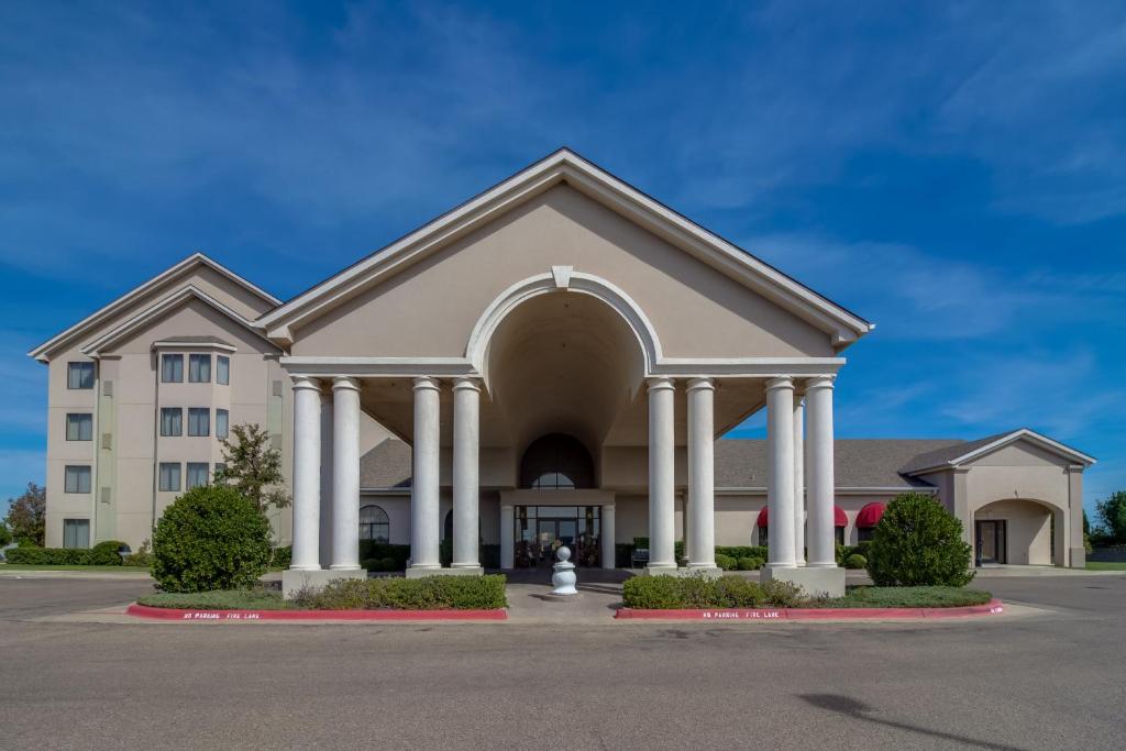 a church with columns and a building at Ashmore Inn and Suites Amarillo in Amarillo