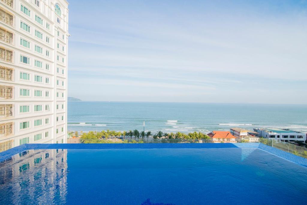 a large swimming pool next to a tall building at Soho Boutique Hotel in Danang