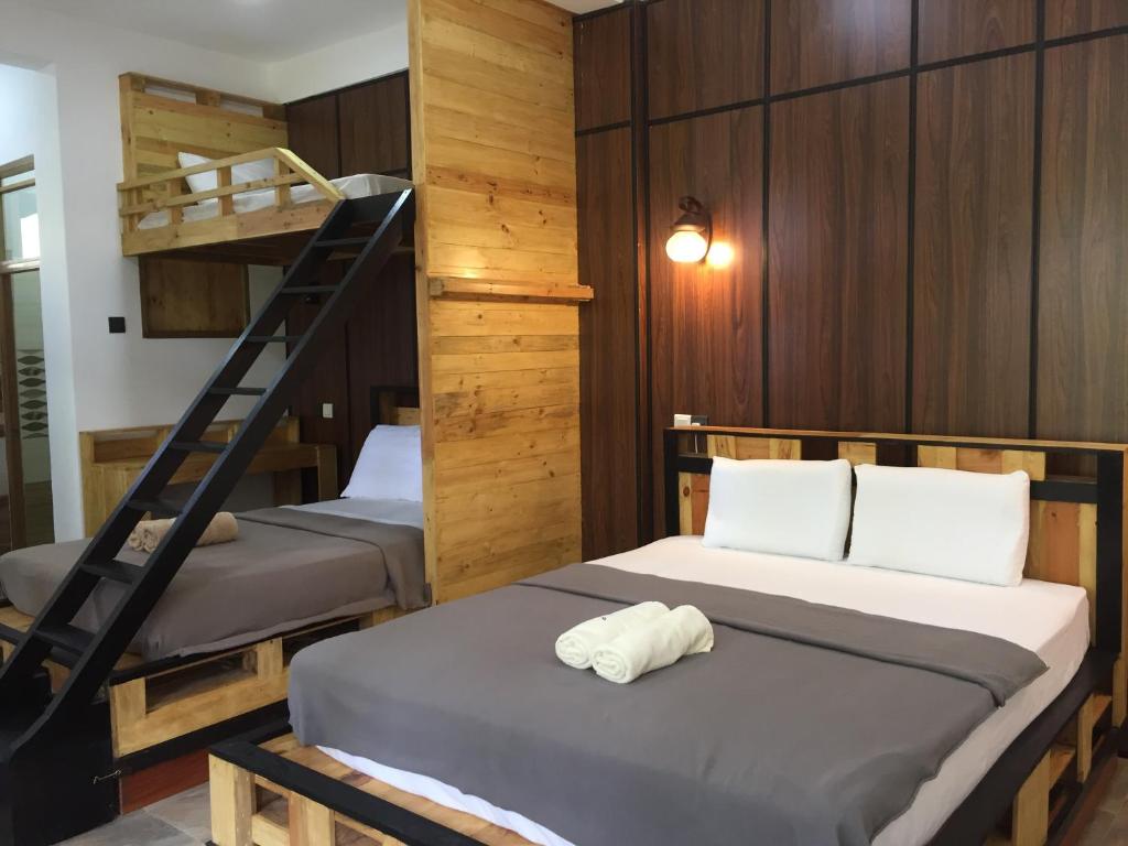 a bedroom with two bunk beds and a staircase at Villa Eden Paradise in Ella