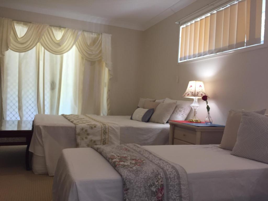 a hotel room with two beds and a window at Deleted in Gold Coast