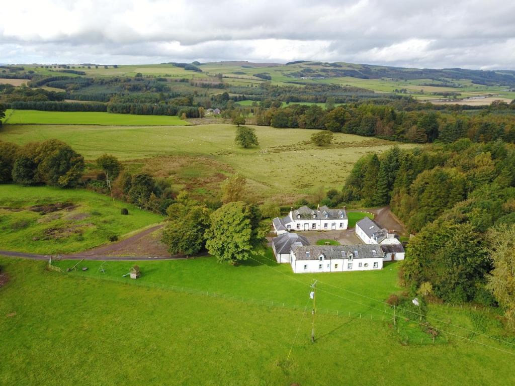 an aerial view of a large house in a field at Kirkwood - Real Farm Holidays & Experiences in Dalton
