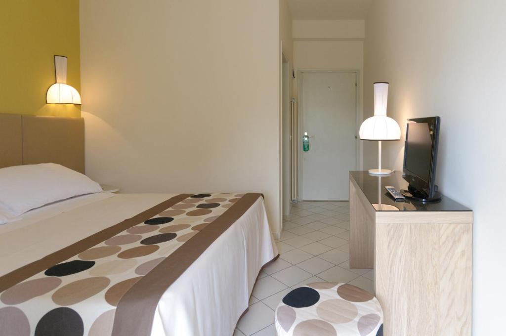 Postel nebo postele na pokoji v ubytování HOTEL TRIONFAL - Fronte Mare - Vicinissimi al Centro