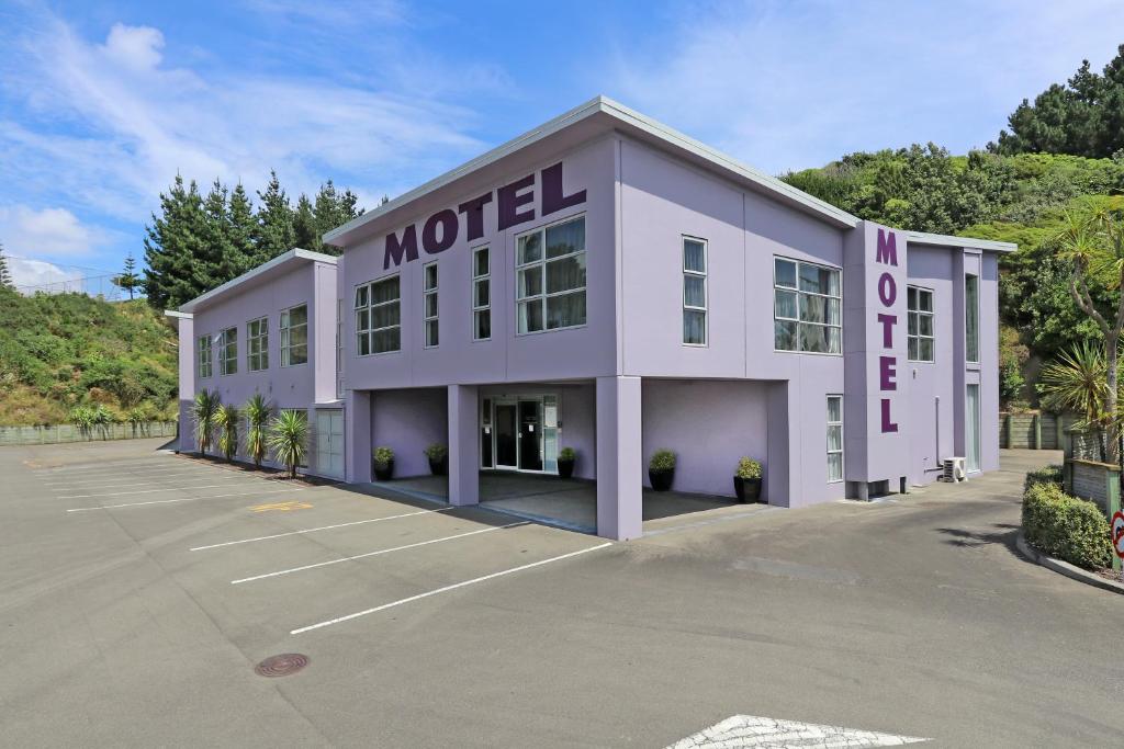 a purple motel with a parking lot at Amethyst Court Motor Lodge in Porirua
