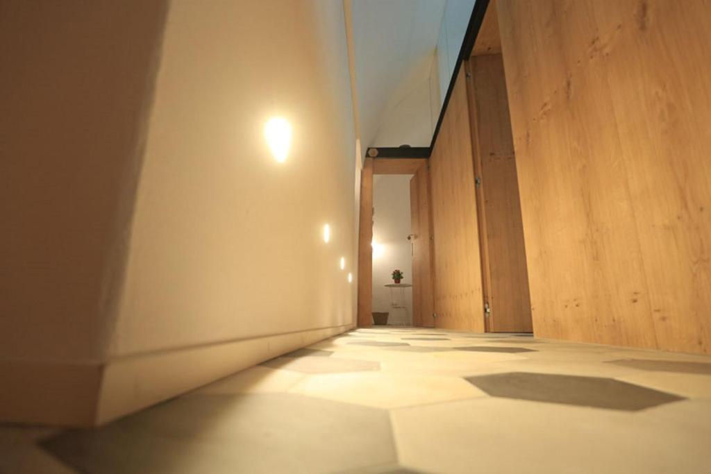 an empty room with a white wall and a tile floor at FONTEblu B&B in Polignano a Mare