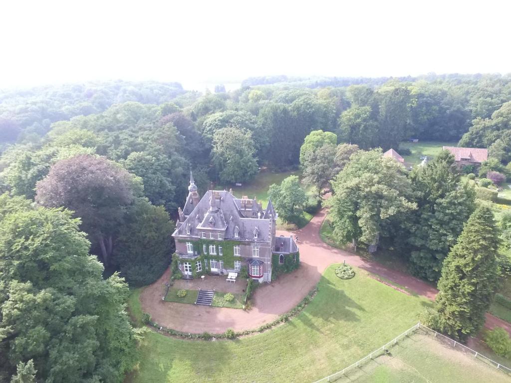 an aerial view of a large house in the forest at Gîte incontournable avec sauna et piscine dans un petit paradis du Barbant wallon in Villers-la-Ville